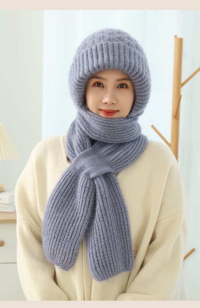Woman wearing a knitted hood with attached scarf
