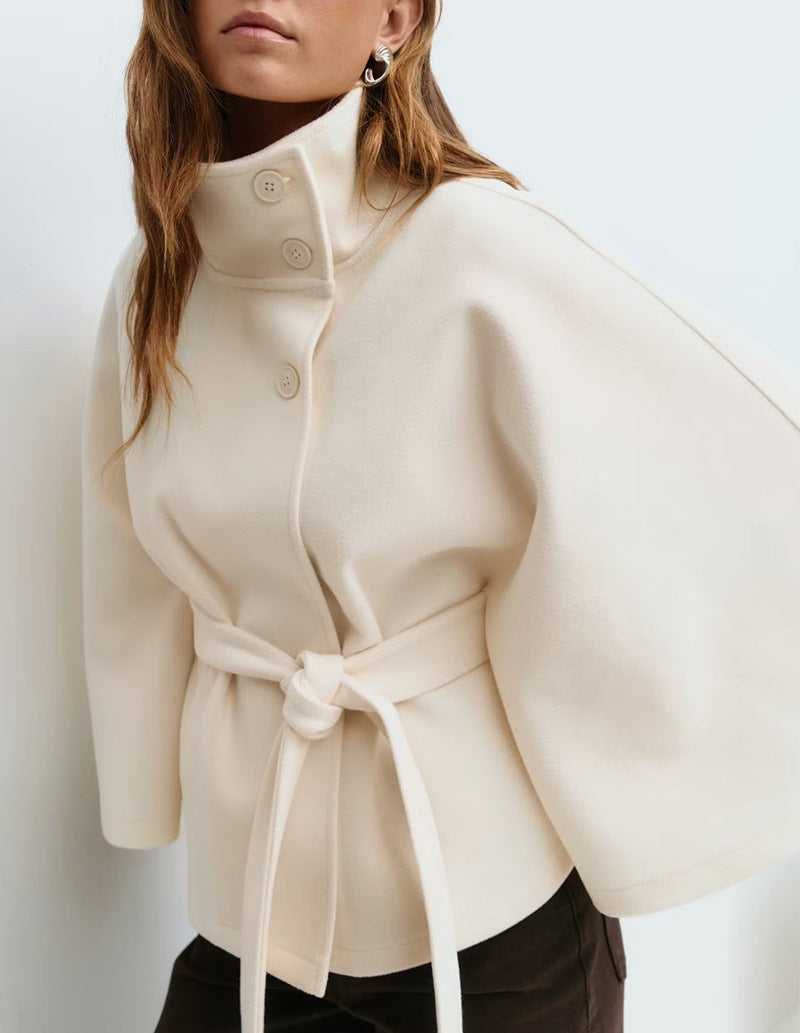 Woman in belted short cape coat