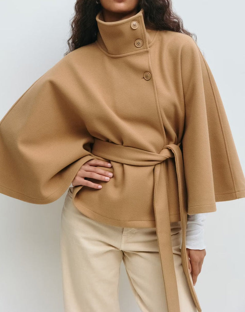 Woman in belted short cape coat