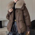 Woman in short puffer jacket with fur collar