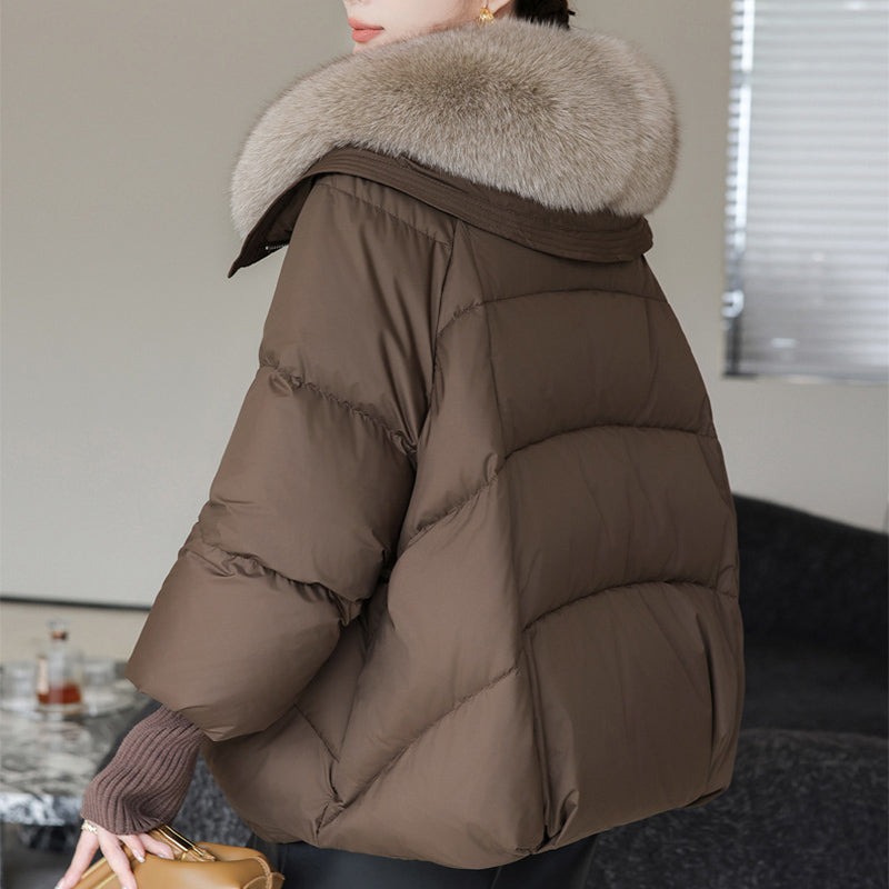 Woman in short puffer jacket with fur collar