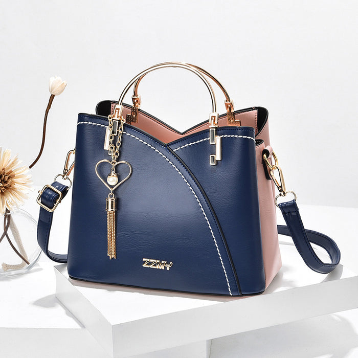 Poppy | Colour block handbag with heart tassel