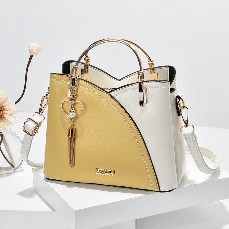Colour block handbag with heart tassel