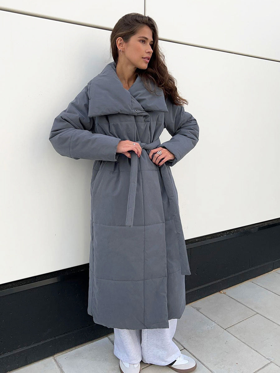 Woman in a long quilted coat with belt