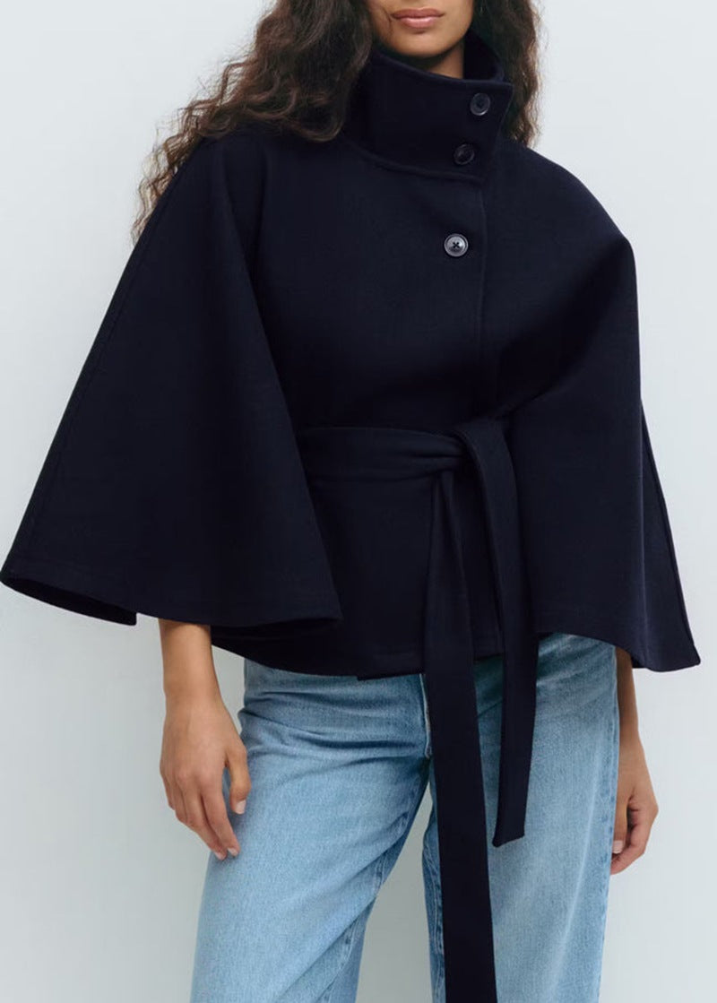 Woman in belted short cape coat