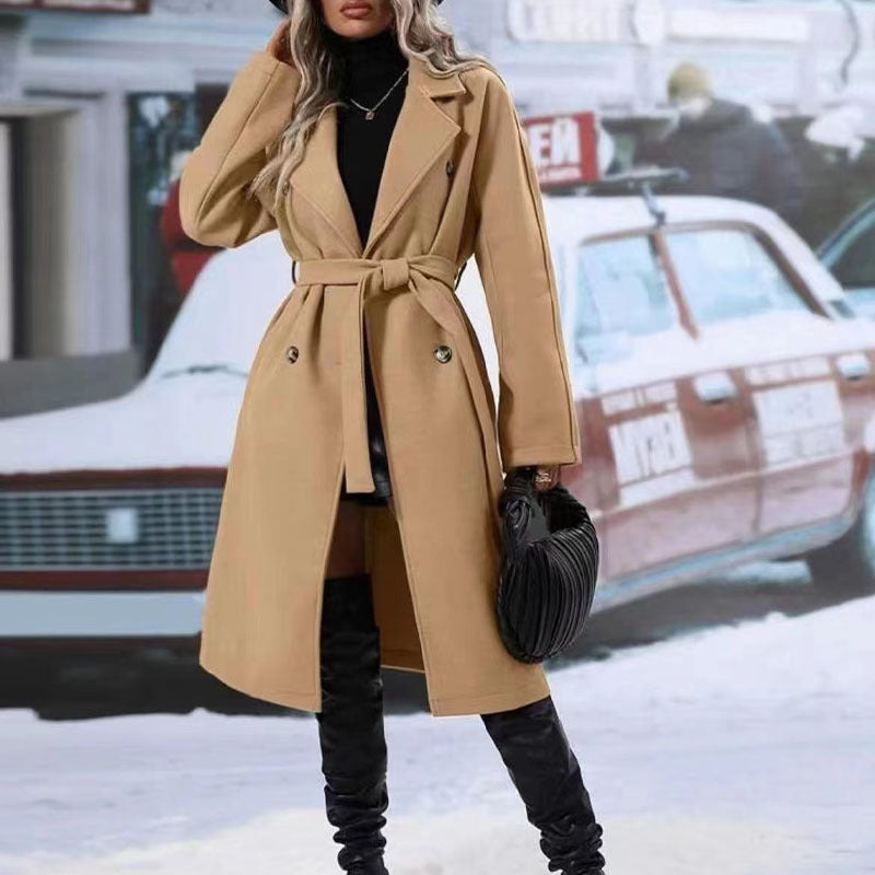 Woman in long belted double-breasted coat