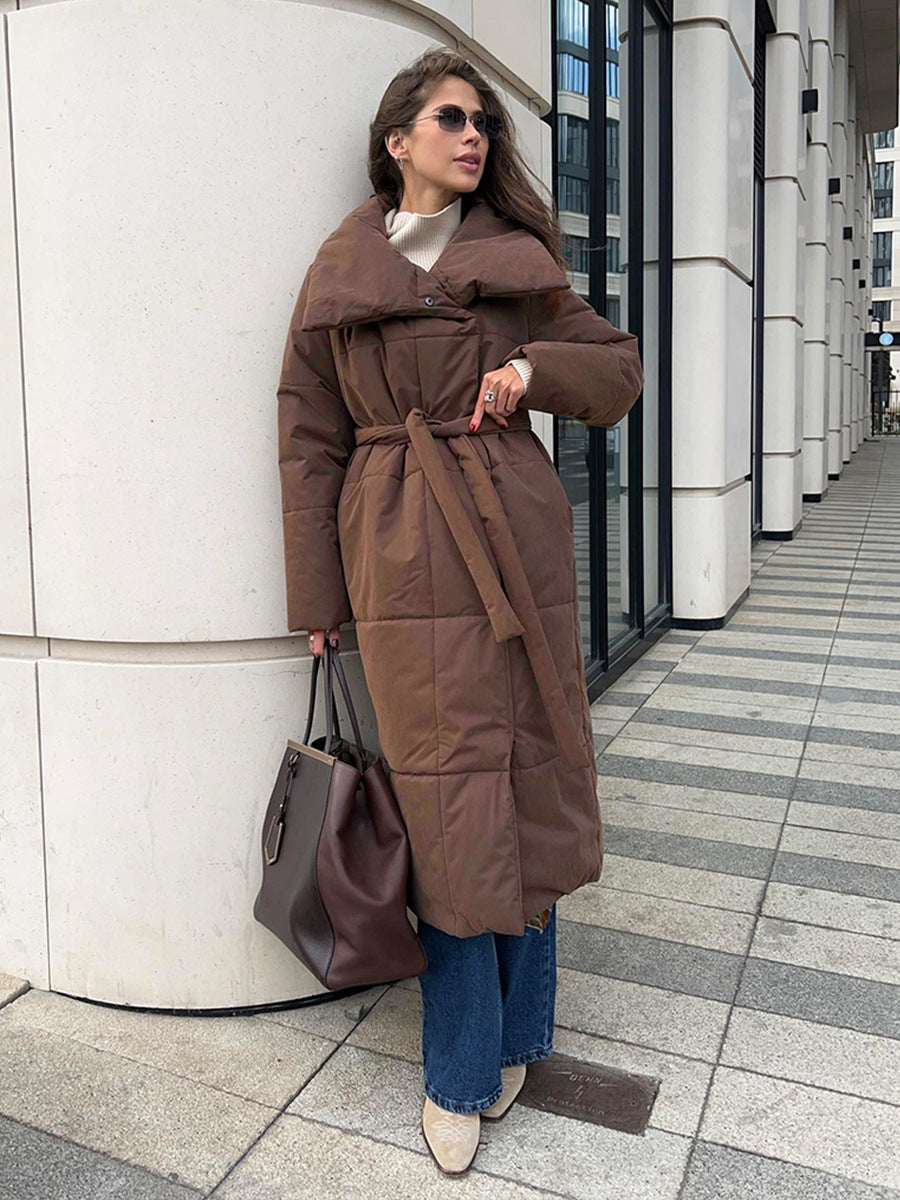 Woman in a long quilted coat with belt