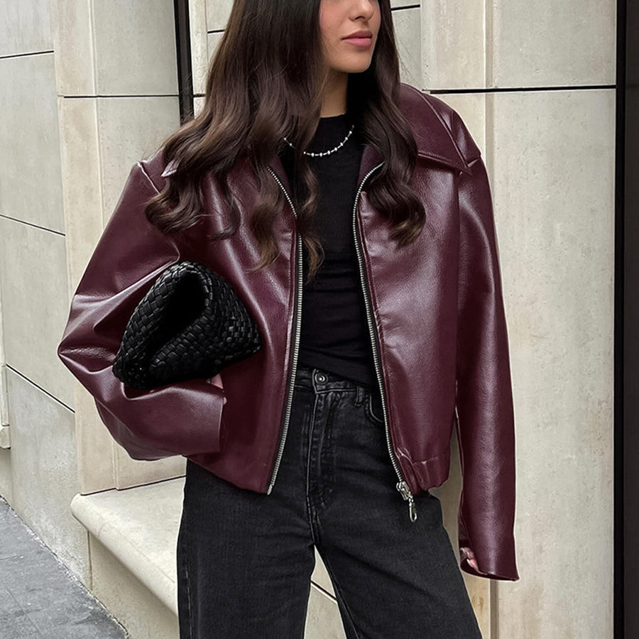 Woman in a cropped burgundy faux leather jacket